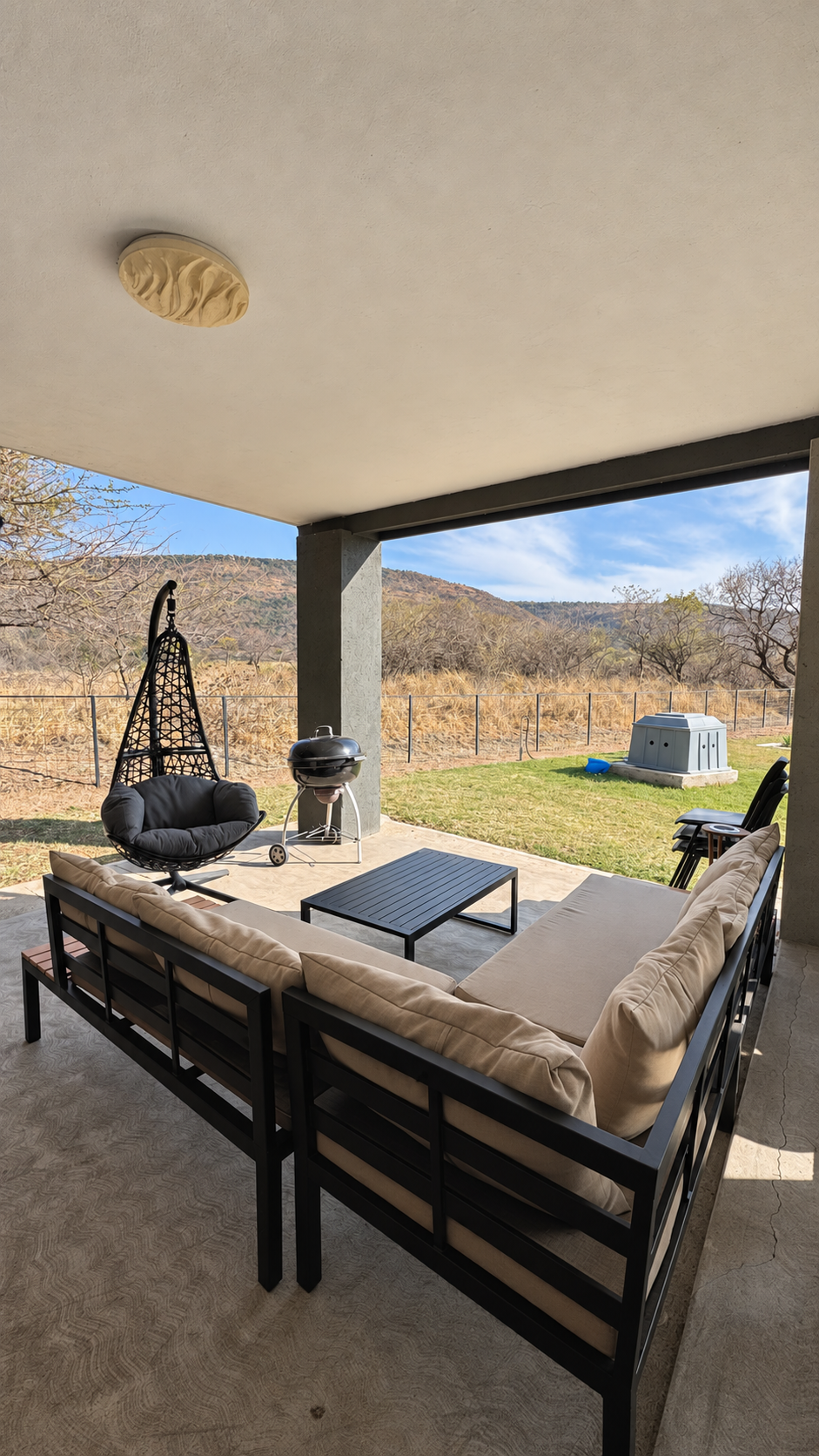 Covered patio lounge with braai overlooking the bush at Sango on 9 Euphoria