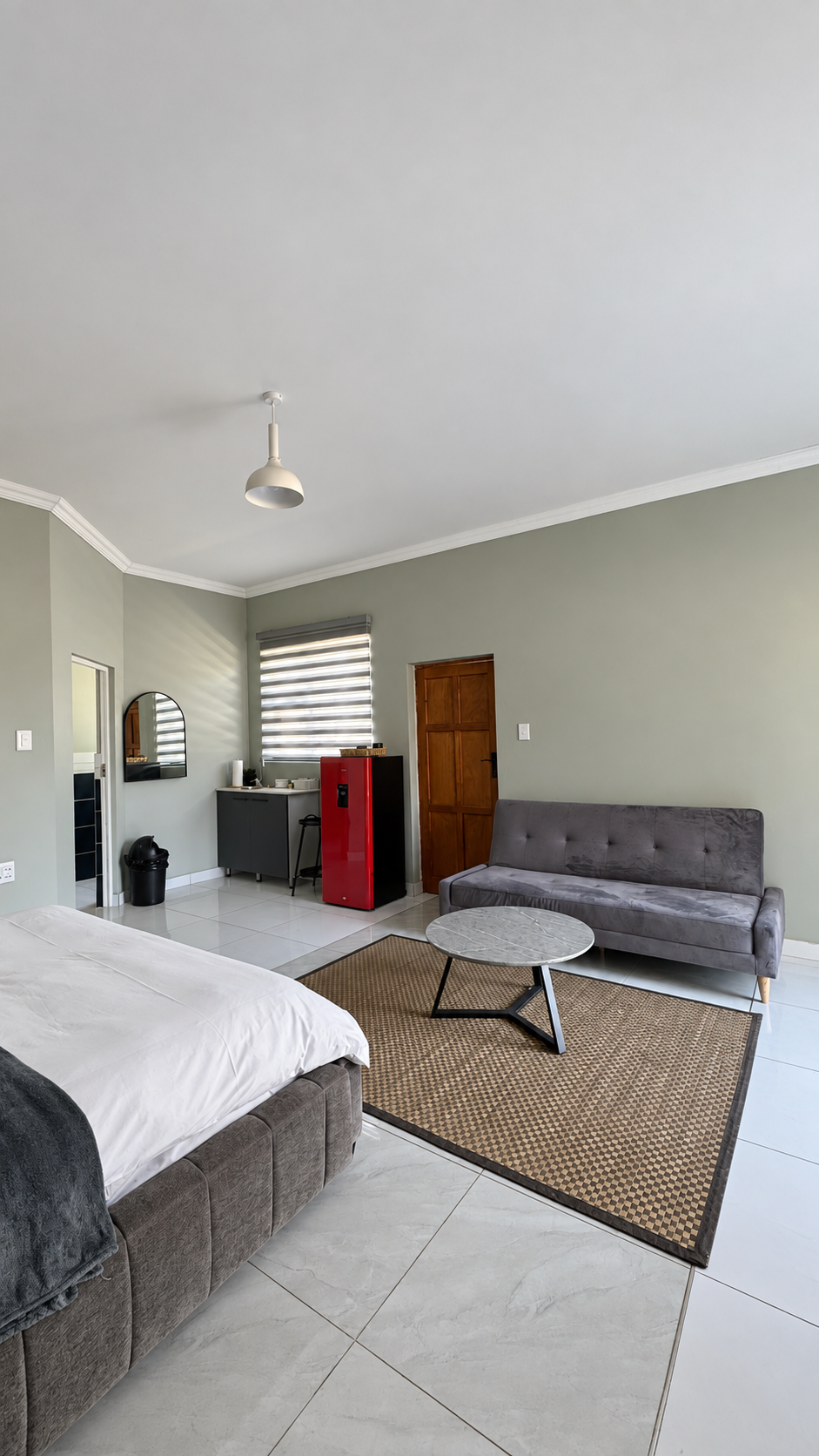 Spacious bedroom suite with lounge corner and kitchenette at Sango on 9 Euphoria
