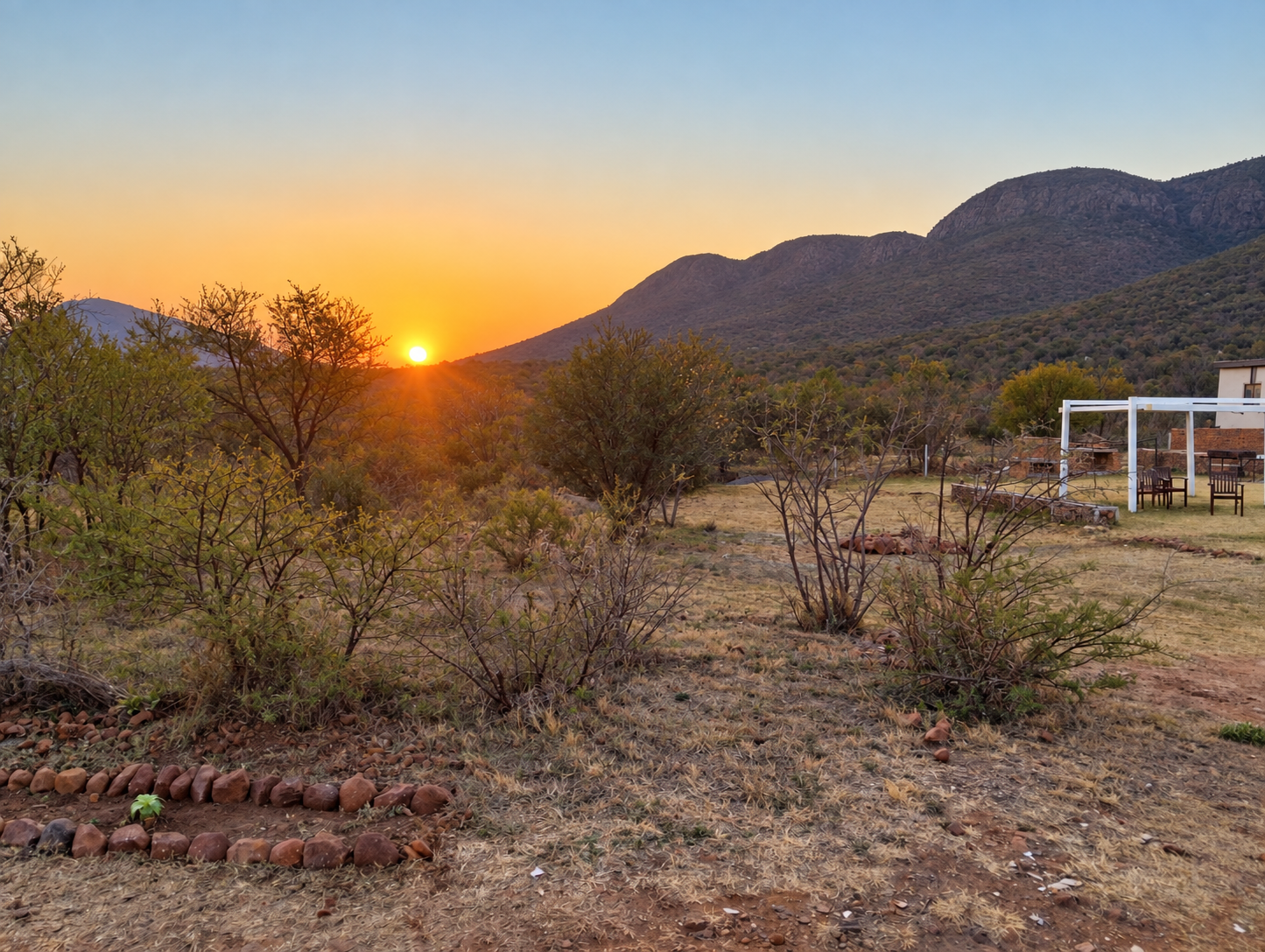 Sunset settling behind the Magaliesberg mountains and bush at Sango Hartbeespoort